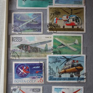 May include: A collection of vintage Soviet Union postage stamps featuring various aircraft, including a Yak-18, a helicopter, and gliders. The stamps are in mint condition and have the text "ПОЧТА СССР" printed on them.