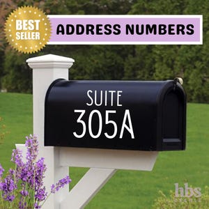 May include: White vinyl address numbers with the text "SUITE 305A" on a black mailbox. The mailbox is mounted on a white post.