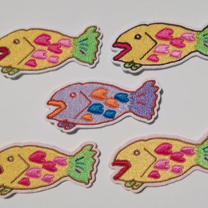 Cute and cheerful homemade iron-on patch featuring fish and heart embroidery. A lovely, bright, and fun homemade embroidered iron-on patch for girls.