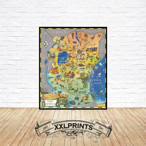 May include: A framed vintage map of East Africa, featuring detailed illustrations of animals and landmarks. The map is colorful, with a focus on the region's geography and wildlife. The frame is black, and the map is displayed against a white brick wall.