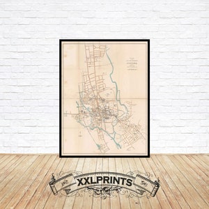 May include: A vintage map of Oxford, England, printed in black and white with blue accents. The map shows the city's streets, buildings, and landmarks. The title "Plan of the City of Oxford" is printed at the top of the map.