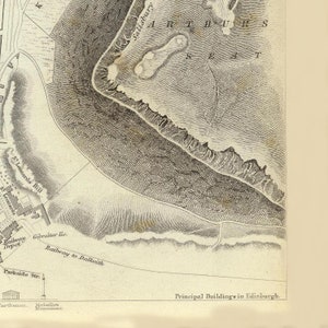 May include: A vintage map of Edinburgh, Scotland, showing the location of Arthur's Seat, a prominent hill in the city. The map also shows the location of Salisbury Crags, a rocky outcrop near Arthur's Seat.