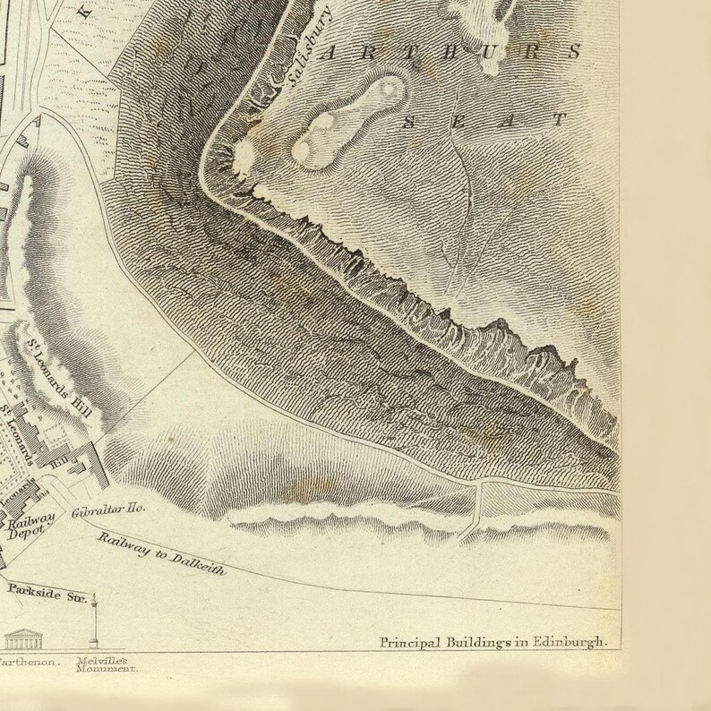 May include: A vintage map of Edinburgh, Scotland, showing the location of Arthur's Seat, a prominent hill in the city. The map also shows the location of Salisbury Crags, a rocky outcrop near Arthur's Seat.