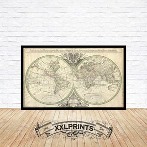 May include: A vintage world map print in black and white with green accents. The map is divided into two hemispheres, with the Americas on the left and Europe, Asia, and Africa on the right. The map is surrounded by a decorative border.
