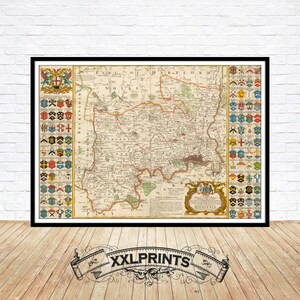 May include: An antique map of Middlesex, England, showing the county's geography and towns in detail. The map is bordered by coats of arms, each representing a different town or village. The map is printed in black and white with a light brown tint.