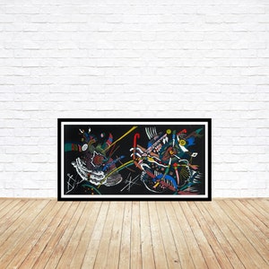 May include: Abstract art print in a black frame. The artwork features a complex composition of shapes and lines in various colors, including red, blue, green, and yellow, set against a black background. The piece is displayed on a wooden floor against a white brick wall.