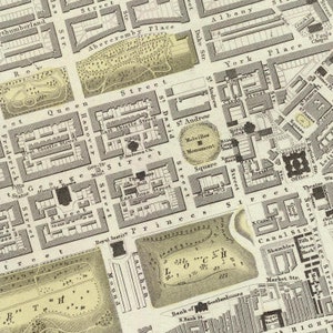 May include: A vintage map of Edinburgh, Scotland, showing the city's streets and landmarks. The map is printed in black and white and features a detailed layout of the city's central area. The map includes the names of streets, squares, and other points of interest.