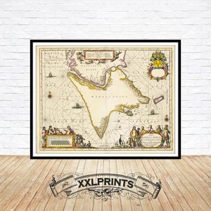 May include: Framed vintage map print with a black border. The map features detailed illustrations and text, with a focus on the region of Magellanica. The map is in shades of beige, yellow, and brown, with decorative elements and text. The bottom of the frame has the text "XXLPRINTS".