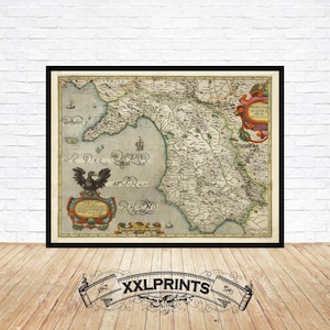 Puede incluir: Impresión enmarcada de un mapa antiguo que presenta una representación detallada de una región costera, probablemente un mapa histórico. El mapa está en tonos apagados con detalles intrincados, incluyendo texto e ilustraciones. El marco es negro y la impresión se muestra en un suelo de madera.