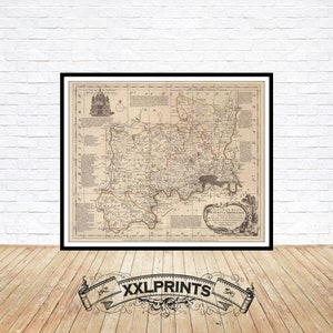 May include: An antique map of the County of Middlesex, England, printed in black and white on a cream-colored paper. The map shows the roads, rivers, and towns of the county. The map is framed in a black frame.