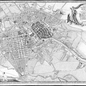 May include: A black and white map of Berlin, Germany, from 1700. The map shows the city's layout, including streets, buildings, and waterways. The map is surrounded by a decorative border with a coat of arms featuring an eagle.