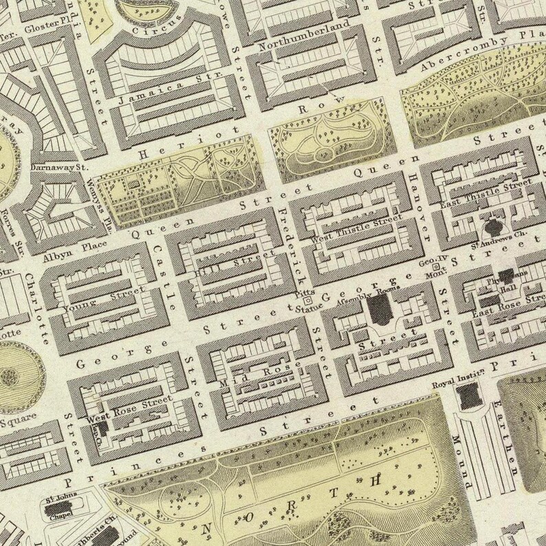 May include: A vintage map of a city with streets and buildings labeled. The map is printed in black and white on a cream-colored background. The map shows the layout of the city with streets, parks, and buildings.