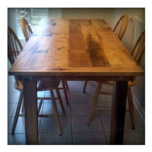 May include: A rustic wooden dining table with a natural wood finish and four chairs. The table has a rectangular top and a simple design.