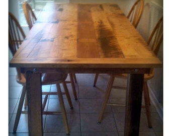 May include: A rustic wooden dining table with a natural wood finish and four chairs. The table has a rectangular top and a simple design.