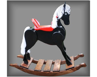 May include: A black wooden rocking horse with a red saddle and white mane and tail. The horse is on a wooden rocking base.
