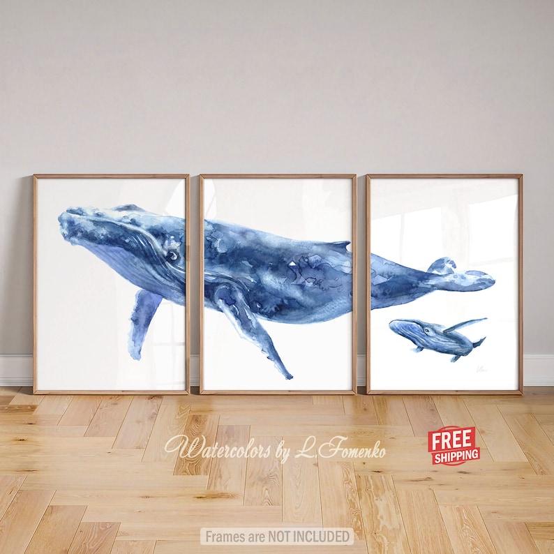 May include: A set of three watercolor paintings featuring a blue whale and a baby whale. The paintings are framed and ready to hang. "Watercolors by L. Fomenko" is written at the bottom of the image.