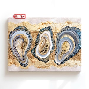 May include: Canvas art featuring three abstract oyster shell designs in shades of blue, white, and gold. The shells are set against a textured gold and beige background, creating a luxurious and artistic aesthetic.
