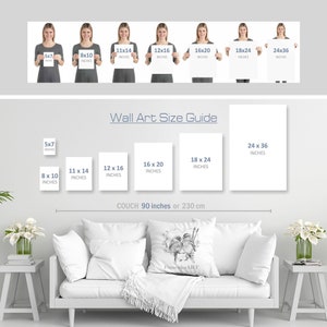May include: A guide to wall art sizes, showing different sizes of prints displayed on a white couch with a throw blanket. The sizes are shown in inches and the couch is 90 inches wide.