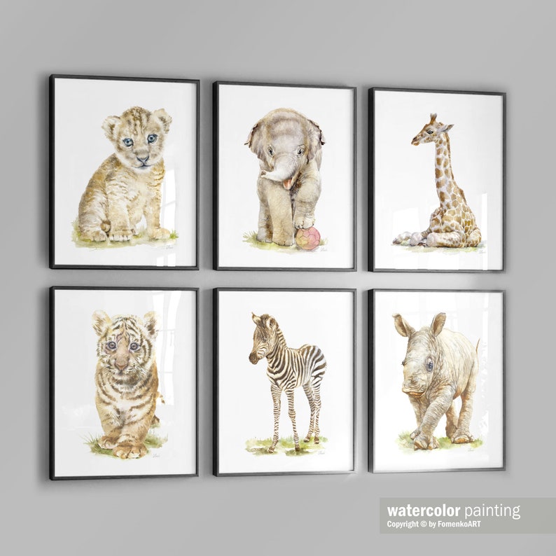 May include: Set of six watercolor paintings featuring baby animals. The paintings include a lion cub, elephant calf, giraffe calf, tiger cub, zebra foal, and rhinoceros calf. Each painting is framed in a black frame.