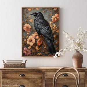 May include: A black raven perched on a branch with pink and orange flowers. The raven has a dark blue-grey body and black eyes. The background is a blue-grey color with a soft, painterly texture.