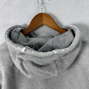 May include: A set of three ceramic mugs with a speckled, matte finish. The mugs are in shades of cream, light brown, and dark brown. Each mug has a simple, minimalist design, perfect for coffee or tea.