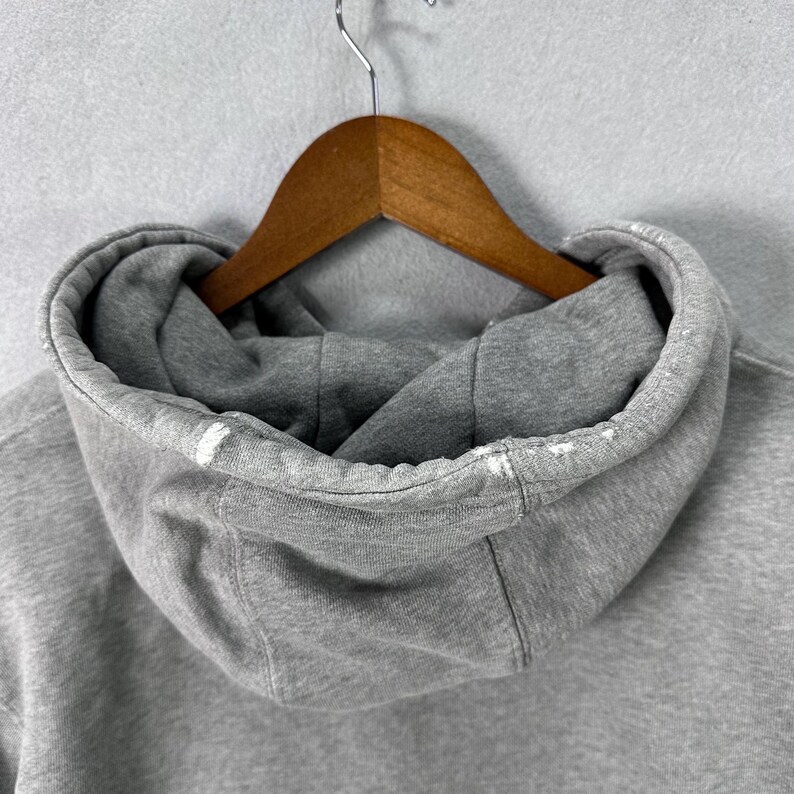 May include: A set of three ceramic mugs with a speckled, matte finish. The mugs are in shades of cream, light brown, and dark brown. Each mug has a simple, minimalist design, perfect for coffee or tea.