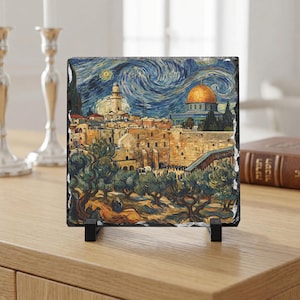 May include: A square, decorative stone tile featuring a painting of Jerusalem in the style of Van Gogh's "Starry Night." The artwork depicts the Dome of the Rock, olive trees, and a night sky with swirling blues and yellows. The tile is displayed on a black stand.