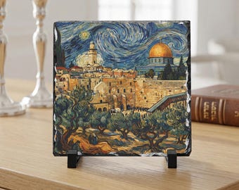 May include: A square, decorative stone tile featuring a painting of Jerusalem in the style of Van Gogh's "Starry Night." The artwork depicts the Dome of the Rock, olive trees, and a night sky with swirling blues and yellows. The tile is displayed on a black stand.