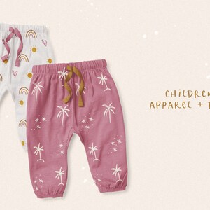 May include: Two pairs of baby pants with different patterns. One pair is white with a rainbow, sun, and heart pattern. The other pair is pink with a palm tree and star pattern. The text "CHILDREN'S APPAREL + DECOR" is written in gold lettering.