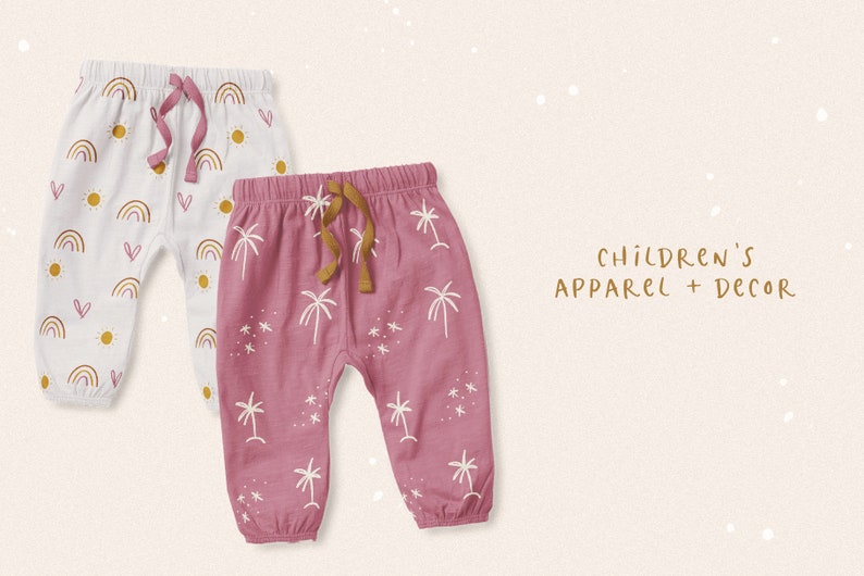 May include: Two pairs of baby pants with different patterns. One pair is white with a rainbow, sun, and heart pattern. The other pair is pink with a palm tree and star pattern. The text "CHILDREN'S APPAREL + DECOR" is written in gold lettering.