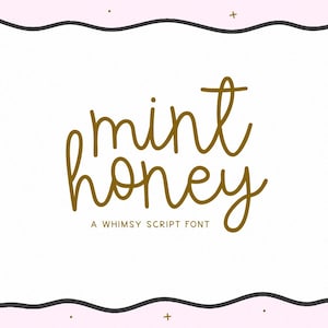 May include: A digital graphic with the words "mint honey" in a whimsical script font. The text is in a gold color and is centered on a white background with a black wavy border. The background is light pink with small gold dots.