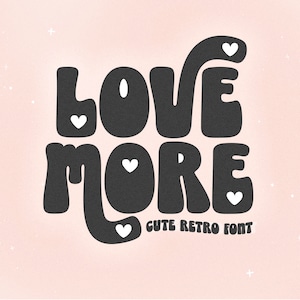 May include: Love More in a cute retro font with white hearts. The text is in black against a pink background.
