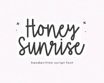 May include: The text Honey Sunrise is written in a dark gray handwritten script font with a white outline. Small black crosses and dots are positioned around the text. Below the main title, the words handwritten script font appear.