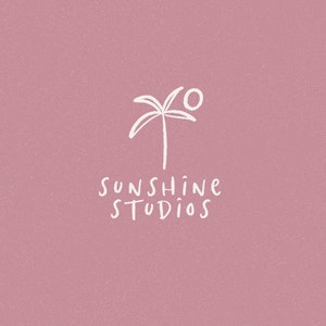 May include: A white palm tree with a white sun above it on a pink background. The text "Sunshine Studios" is below the palm tree.
