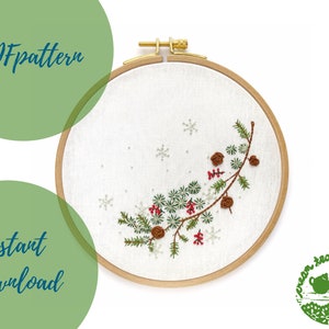 May include: A PDF pattern for a winter-themed embroidery project featuring a pine branch with red berries and brown pine cones. The embroidery is displayed in a wooden embroidery hoop on a white background. The text "PDF pattern" and "instant download" is displayed in green circles.