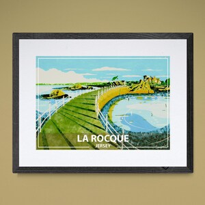 May include: A colorful illustration of La Rocque, Jersey, featuring a green grassy path leading to a small body of water. The text "LA ROCQUE JERSEY" is printed below the image.