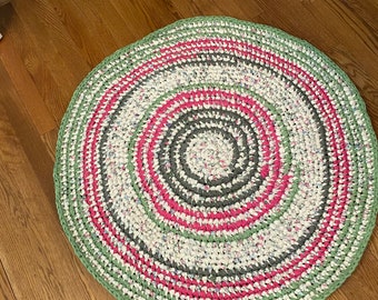 Pink green white scrubby 36” spiral rug. Handmade with recycled linens. Sustainable, durable, washable, unique. Nursery, sunroom, bath, bed