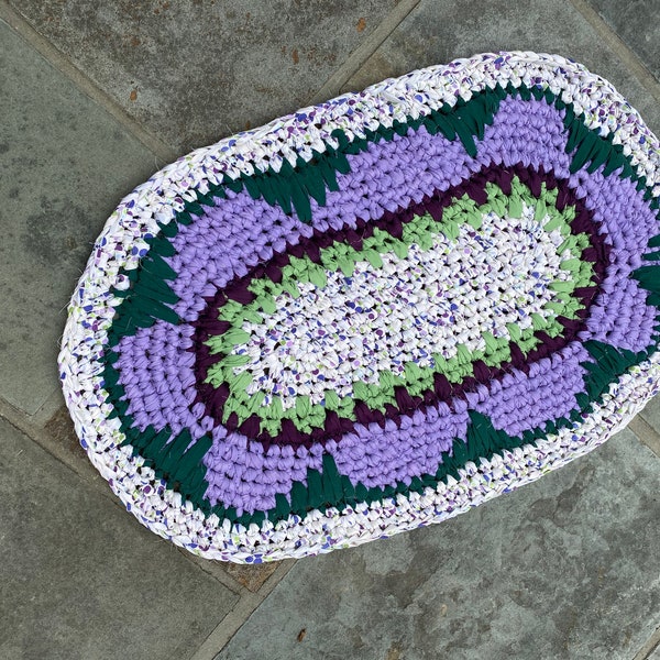 Cotton rag rug crocheted with recycled linens. Washable, durable, sustainable, reversible. Purple green white 30x20 flower power hippie