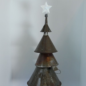 May include: A rustic Christmas tree sculpture made from repurposed metal funnels. The tree is topped with a glittery star and sits on a base with a wire mesh and colorful LED lights. The tree is approximately 24 inches tall.