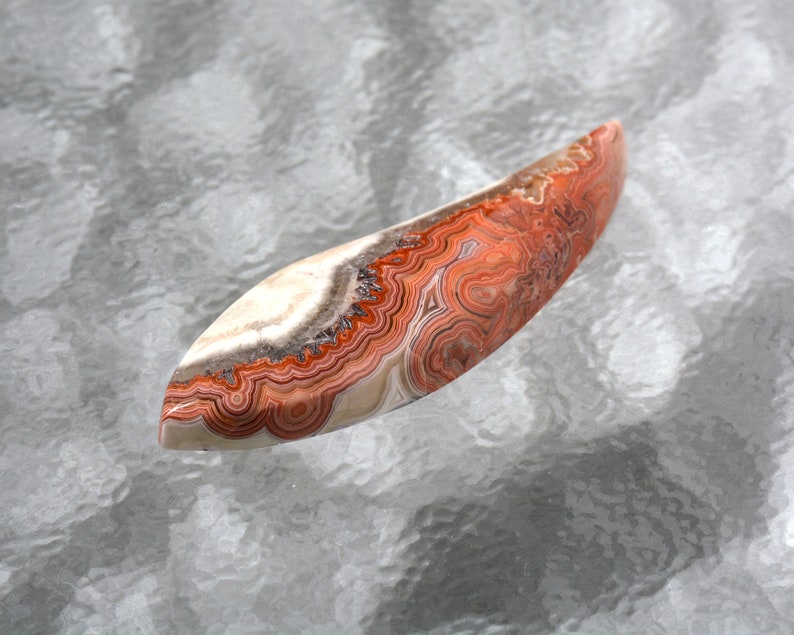 Laguna Agate Hand Cut Free Form Designer Cabochon With Fortification Patterns in Reds Grays and White Colors 51.3 x 16.6 x 6.3mm #4229LAG