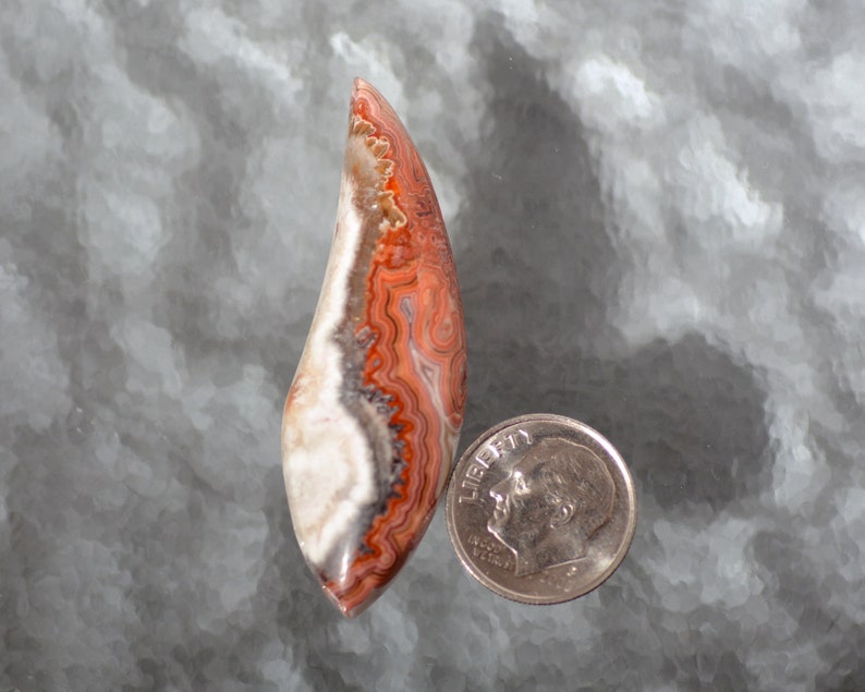 Laguna Agate Hand Cut Free Form Designer Cabochon With Fortification Patterns in Reds Grays and White Colors 51.3 x 16.6 x 6.3mm #4229LAG
