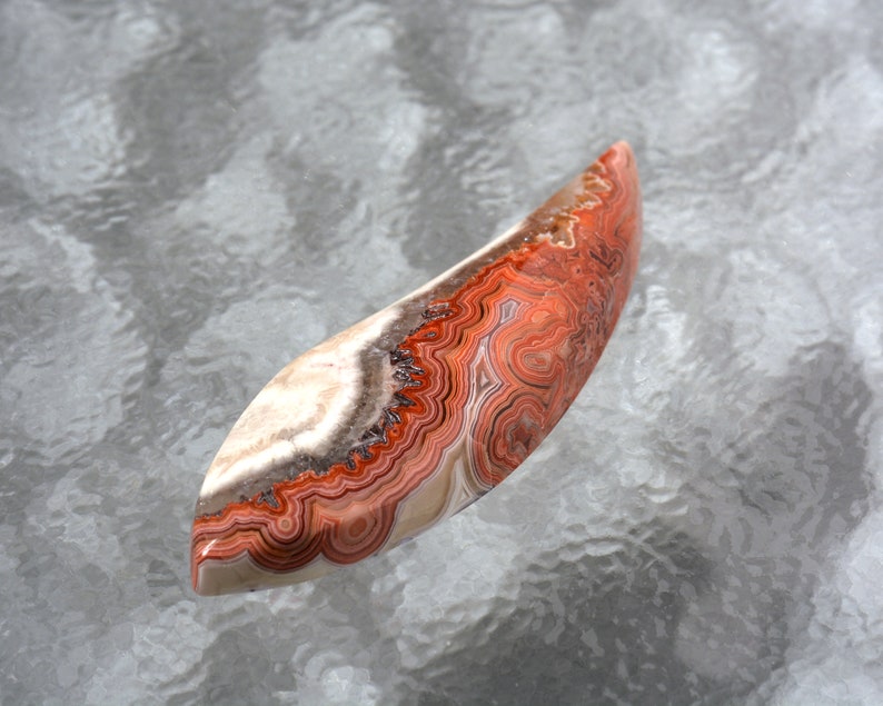 Laguna Agate Hand Cut Free Form Designer Cabochon With Fortification Patterns in Reds Grays and White Colors 51.3 x 16.6 x 6.3mm #4229LAG