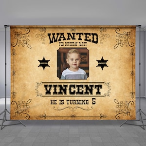 May include: A vintage-style "Wanted" poster with a photo of a young boy. The poster is brown and has black text that reads "WANTED FOR BIRTHDAY PARTY", "VINCENT", and "HE IS TURNING 5". There are two black sheriff stars on the poster.