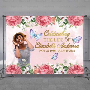 May include: A pink and white floral backdrop with butterflies and the text "Celebrating the Life of Elizabeth Anderson Nov 22 1980 - July 19 2018".
