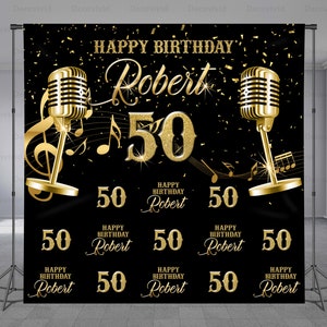 May include: Black and gold backdrop with the text "Happy Birthday Robert 50" and gold microphones. The backdrop also features multiple smaller versions of the text "Happy Birthday Robert 50".