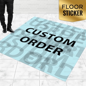 May include: A light blue floor sticker with the words "CUSTOM ORDER" in black text. The sticker is designed to look like a rug with a pattern of overlapping letters.