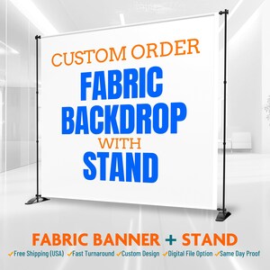 May include: A white fabric backdrop with the text "CUSTOM ORDER FABRIC BACKDROP WITH STAND" in blue and orange. The backdrop is supported by a black stand. The words "FABRIC BANNER + STAND" are at the bottom.