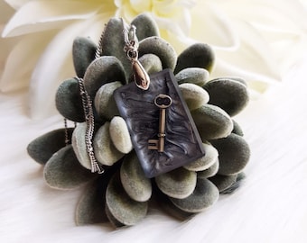 Floating Skeleton Key Shimmering Swirl Gunmetal Gray and Black Resin Pendant Necklace