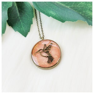 Metallic Peach and Antiqued Bronze Hummingbird Oval Bezel Resin Pendant Necklace