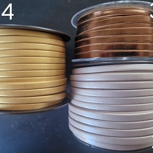 Pu&ograve; includere: Tre bobine di cordino in pelle piatta etichettate 34, 35 e 36. La bobina 34 &egrave; oro metallizzato, la bobina 35 &egrave; rame metallizzato e la bobina 36 &egrave; beige chiaro opaco. Ogni bobina &egrave; avvolta con una lunghezza continua di cordino in pelle piatta.